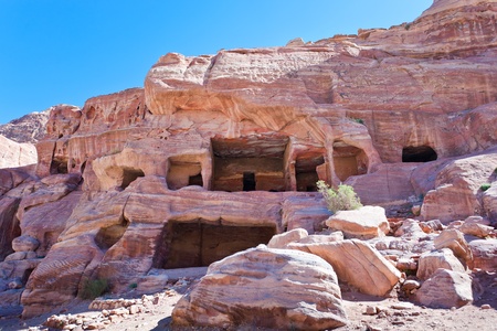 13095974-ancient-stone-houses-on-facade-street-in-petra-jordan.jpg